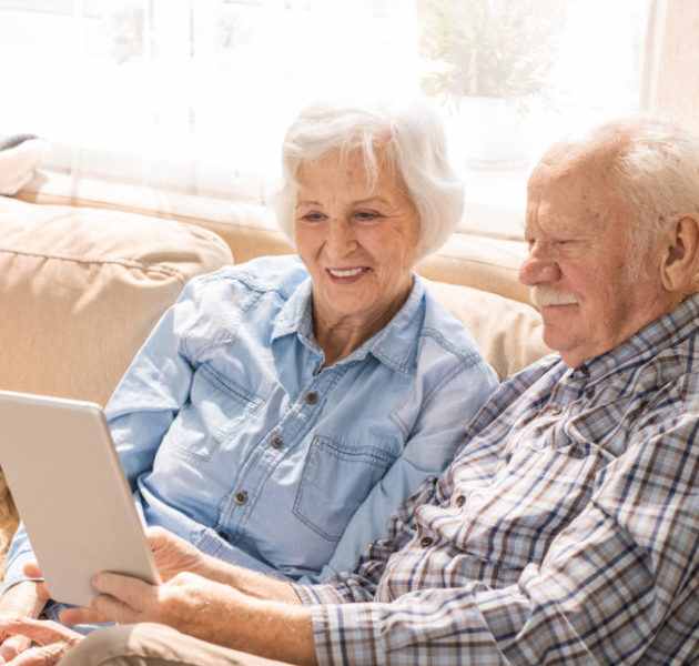 People sat on sofa with Ipad