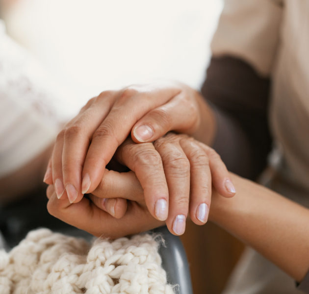 carer-holding-elderly-womans-hand