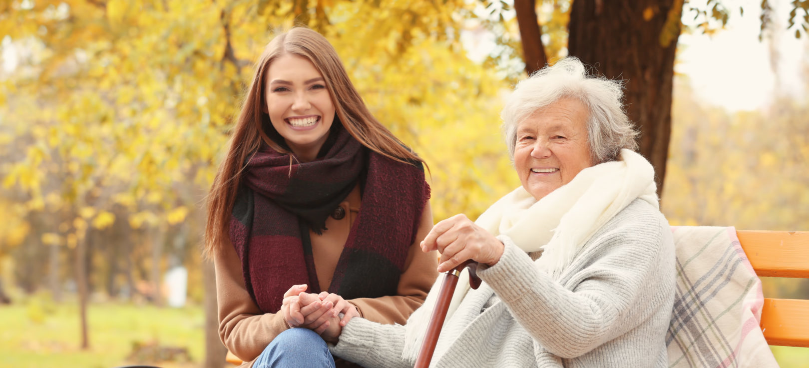 Young care giver and senior woman in the park